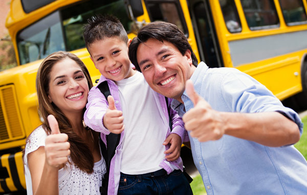 family in front of school bus